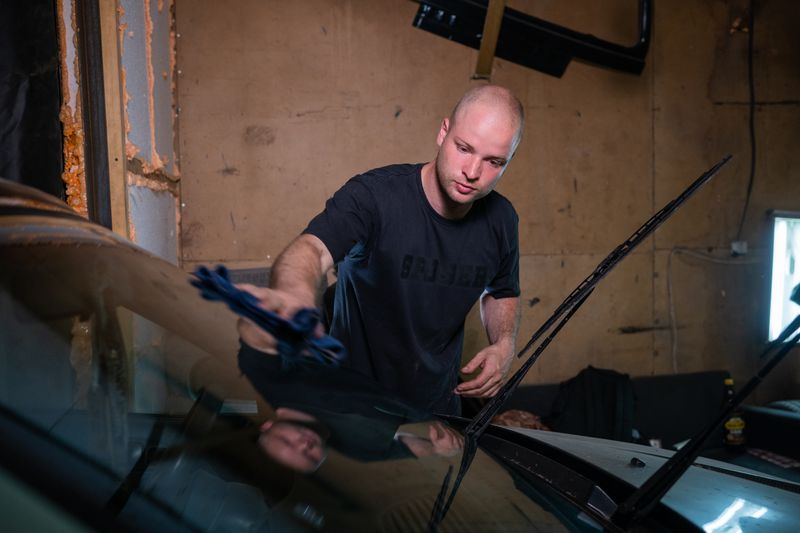 Technician replacing a windshield