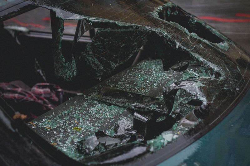 Vehicle with shattered auto glass being replaced